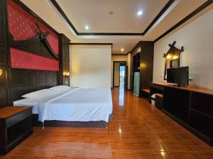 a bedroom with a bed and a flat screen tv at Nanai 2 Residence Patong Phuket in Patong Beach
