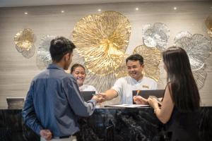 a group of people standing around a table at SAM E Hotel Bangkok Sathorn in Bangkok
