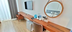 a room with a dressing table and a mirror at VangVieng Crystal Boutique Hotel in Vang Vieng