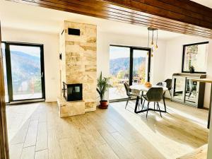 a living room with a table and a fireplace at Stone House Sinaia in Sinaia