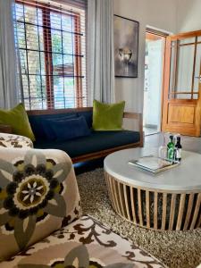 a living room with a couch and a coffee table at Meerendal Boutique Hotel in Durbanville +30 photos