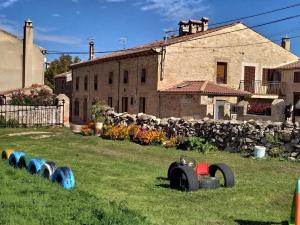 a row of tires in the grass in front of a building at Casa "El Villar" in Matabuena