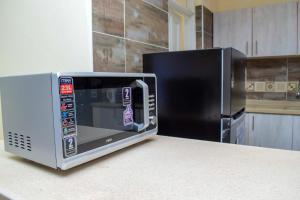 a microwave oven sitting on a counter in a kitchen at Millan Homes in Mombasa