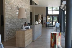 a lobby with a reception desk in a building at Domaine du Ferret Restaurant & Spa in Cap-Ferret