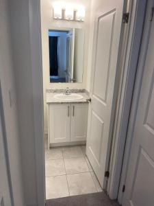 a bathroom with a sink and a mirror at Luxury Brand New Townhouse In Milton Ontario in Milton