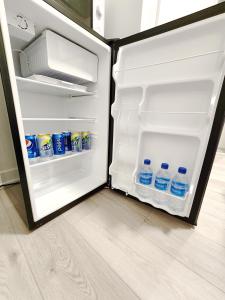 an open refrigerator with bottles of water in it at Toronto Downtown Midtown North York Newly Built Modern Bright Room in Toronto