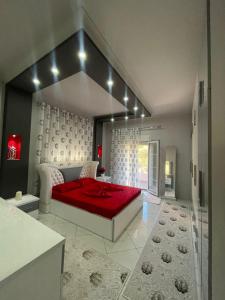 1 dormitorio con 1 cama con manta roja en Dervishi’s apartment, 
