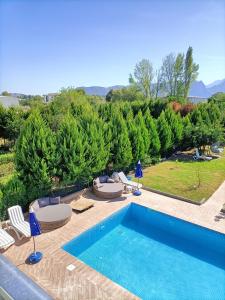 a swimming pool with chaise lounge chairs and a swimming pool at Holistic Balance 