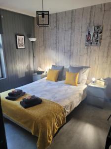a bedroom with a large bed with yellow pillows at My bedroom in Spa