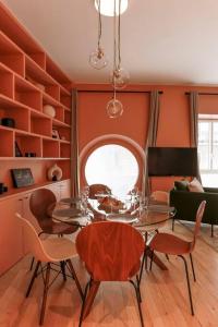 uma sala de jantar com paredes cor de laranja e uma mesa e cadeiras em Modern 2 bedrooms near Louvre em Paris