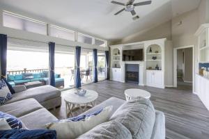 a living room with a couch and a table at Capri Charm Remodeled Oasis w/ Heated Pool-Kayaks in Naples