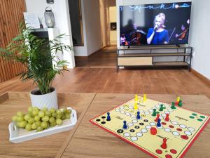 a living room with a table with fruit and a television at homey Apartments Park Suite in Bremerhaven
