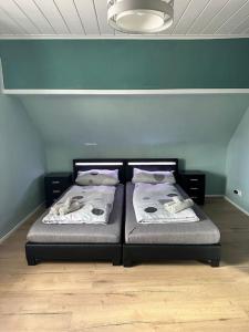 two beds sitting next to each other in a room at Gemütliche Wohnung in Pforzheim in Pforzheim
