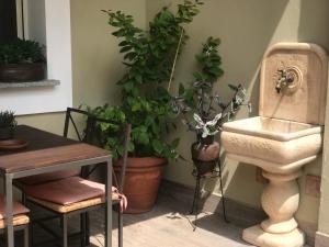 a bathroom with plants and a sink and a table at b&b IL QUADRATO 19 in Nerviano