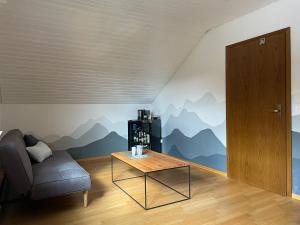 a living room with a couch and a table at Herzliches Zimmer im Zürcher Oberland in Wald