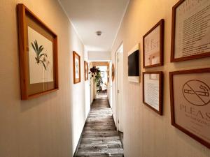 a long hallway with pictures on the walls at departamento encantador céntrico con balcon in Lima