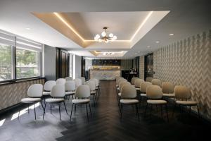 a room with a row of chairs and a fireplace at The Anndore House, part of JDV by Hyatt in Toronto