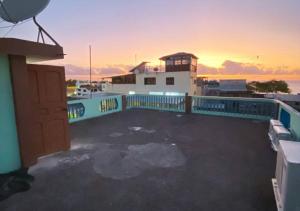 una azotea de un edificio con una puesta de sol en el fondo en Blue Horizon, Galápagos, en Puerto Baquerizo Moreno