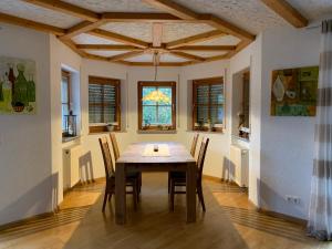a dining room with a wooden table and chairs at Ferienwohnung Haffner in Kandern