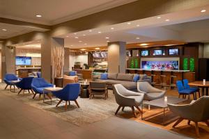 a hotel lobby with blue chairs and a bar at Courtyard by Marriott Toronto Downtown in Toronto