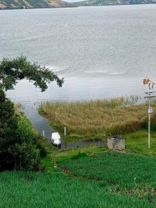 a view of a lake with a boat in the water at Cabañas el Olimpo in Aquitania