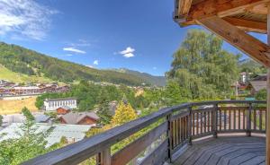 a balcony with a view of a town and mountains at Albatros in Morzine