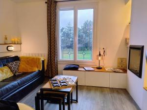 a living room with a couch and a table and a window at Ti Kabanouz in Arzon