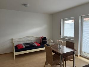 a bedroom with a bed and a table with chairs at F&M Wohnungen in Olpe in Wenden