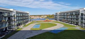 an aerial view of two apartment buildings with a playground at Baltic Nature Apartment & SPA in Dziwnów