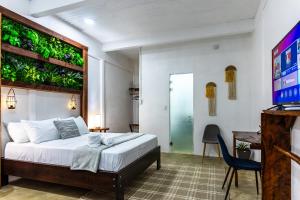 sypialnia z łóżkiem z roślinami na ścianie w obiekcie El Deseo Serendipity Tortuguero w mieście Tortuguero