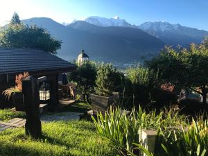 een uitzicht op een huis met bergen op de achtergrond bij Les Greniers du Mont Blanc in Passy