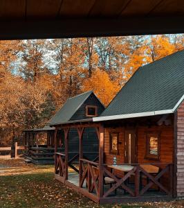 a log cabin with a black roof at Domek pod śnieżką 1 in Karpacz