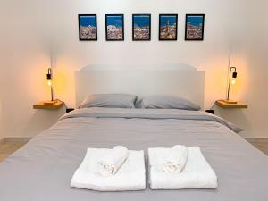 a bedroom with a bed with two towels on it at Le Vie del Borgo in Sannicandro di Bari