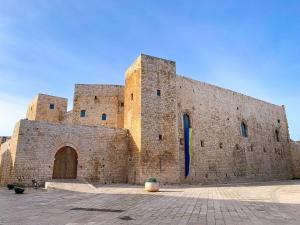 a large brick building with a large door at Le Vie del Borgo in Sannicandro di Bari