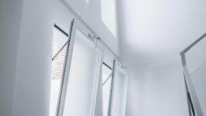 a row of glass windows in a building at Catalina Suites Apartments Downtown Valencia in Valencia +28 photos