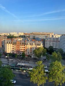 a view of a city with buildings and a parking lot at Private room in a shared apartment - Metro 7 and Tramway T3a in Paris