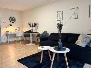 a living room with a couch and a table at Charming Homes - Studio 16 in Wolfsburg