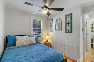 a bedroom with a blue bed and a ceiling fan at Cute & Cozy 2/1 Lakeview House on Chain O Lakes in Fox Lake