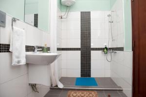 a bathroom with a sink and a shower at The Pearl Cottages in Kampala +38 photos