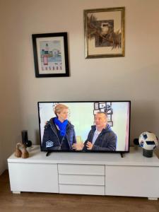 a flat screen tv sitting on top of a white cabinet at Appartement 3 pièces AlfortVille Centre in Alfortville