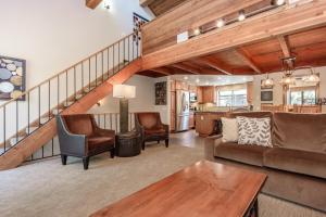 a living room with a couch and a table at Snowflower #47 - Updated 2 Bedroom & Loft, 3 Bath, Sleeps 8, Steps away from Free Town Shuttle in Mammoth Lakes