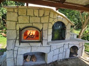 a stone oven with a fire inside of it at Sielskie Klimaty in Marcinowice +5 photos