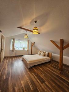 a bedroom with a bed and a cross on the wall at Sielskie Klimaty in Marcinowice