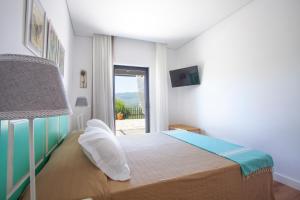 a bedroom with a bed and a window with a view at Quinta da Pitarrela in Peso da Régua +126 photos