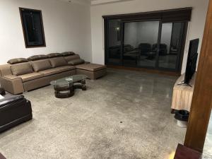 a living room with a couch and a tv at S Pool Villa Clark 天天别墅酒店 in Angeles