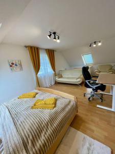 a bedroom with a bed and a desk and a chair at Neuenhagen Haven in Neuenhagen +13 photos