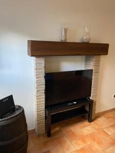 a living room with a fireplace with a flat screen tv at civico 8 in Viterbo