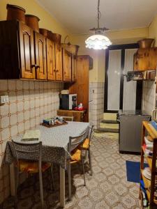 a kitchen with a table and chairs in a room at LA CORTE DELLA CARLA - cozy home in the old court in Lierna