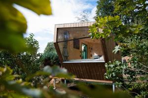 a glass house in the middle of a forest at Friesland Glamping Camp Schortens in Schortens