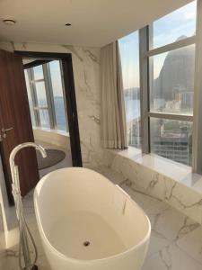 a white bath tub in a bathroom with a window at Hotel Nacional Rio de Janeiro in Rio de Janeiro